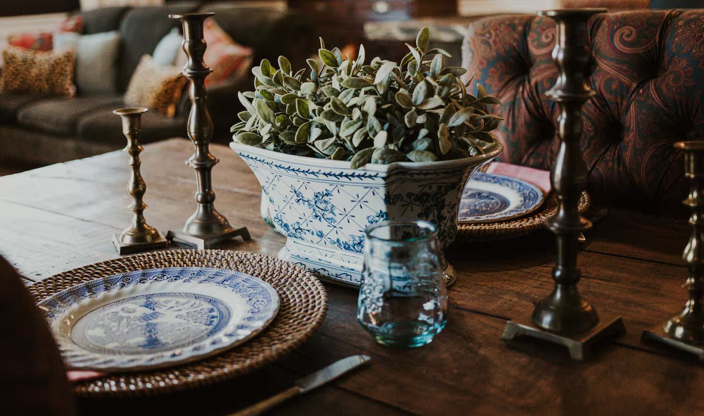 Place settings include dishware and silverware for multi-course dining, with additional pieces for sides and main dishes.