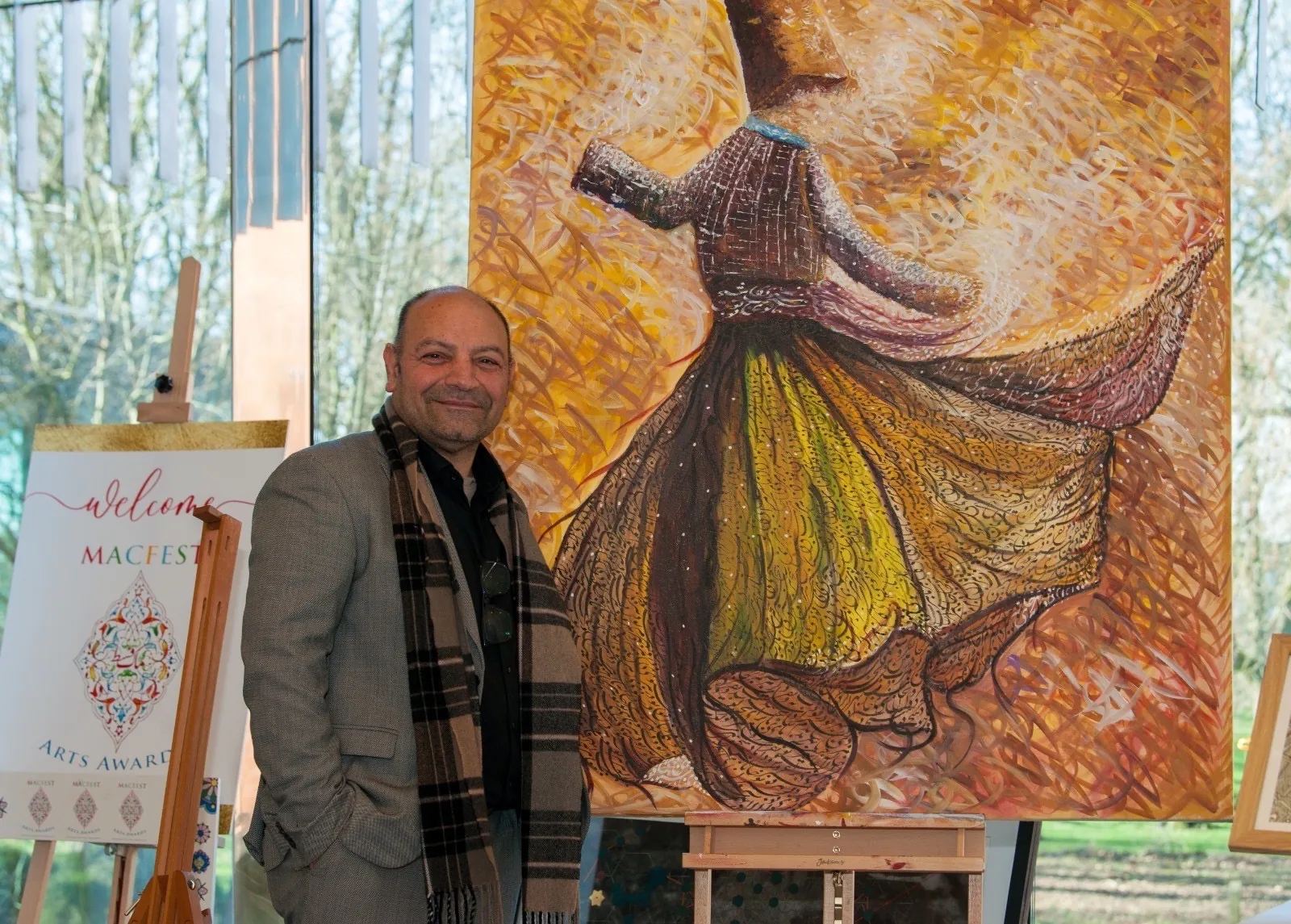 Mohammad Aman Popal beside 'Rumi Devotion' at the MACFEST Muslim Arts Awards exhibition