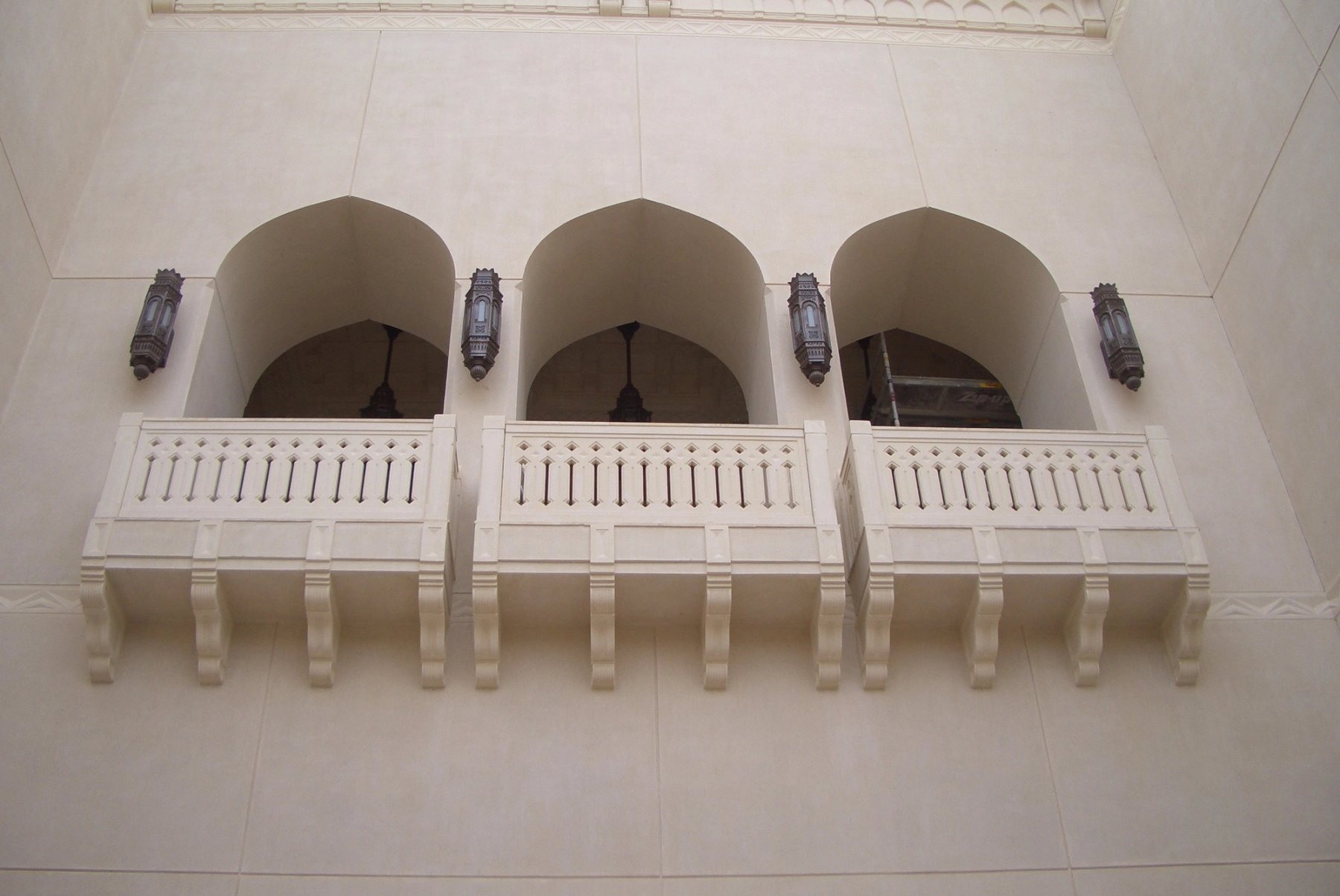 Decorative balcony composition with pointed arches, balustrades and architectural lanterns