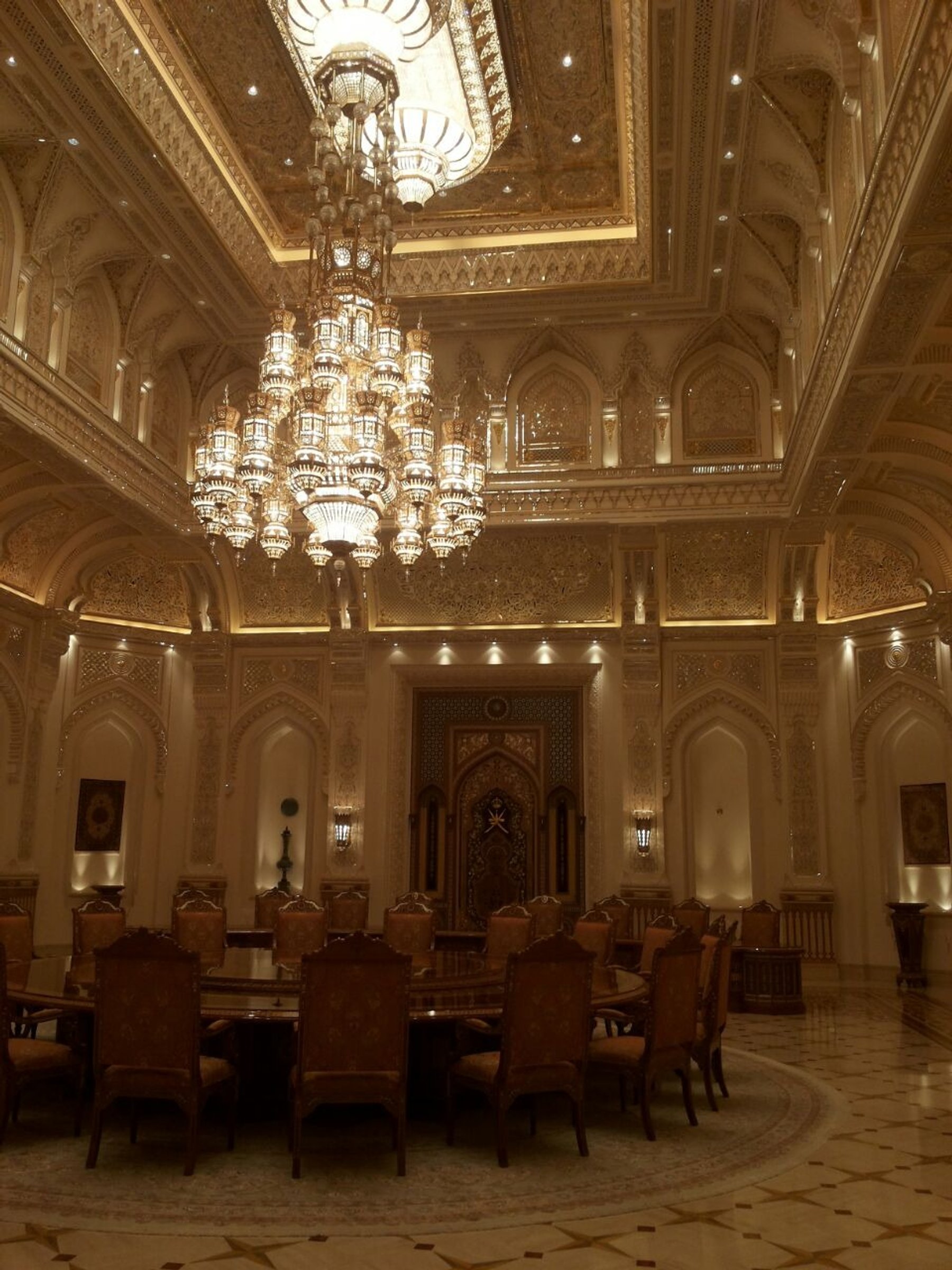 Grand formal interior with chandeliers and layered decorative ceiling details