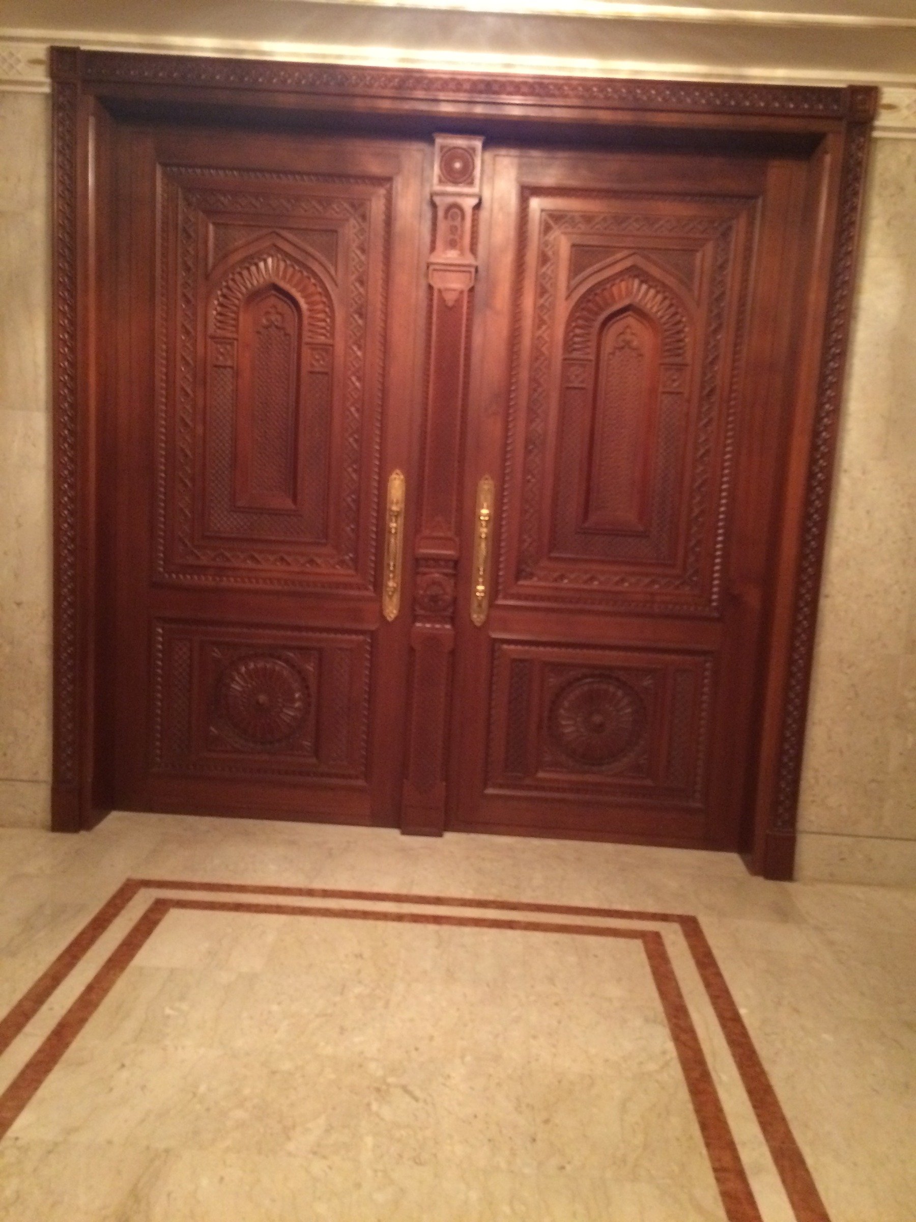 Carved timber double doors with geometric architectural detailing