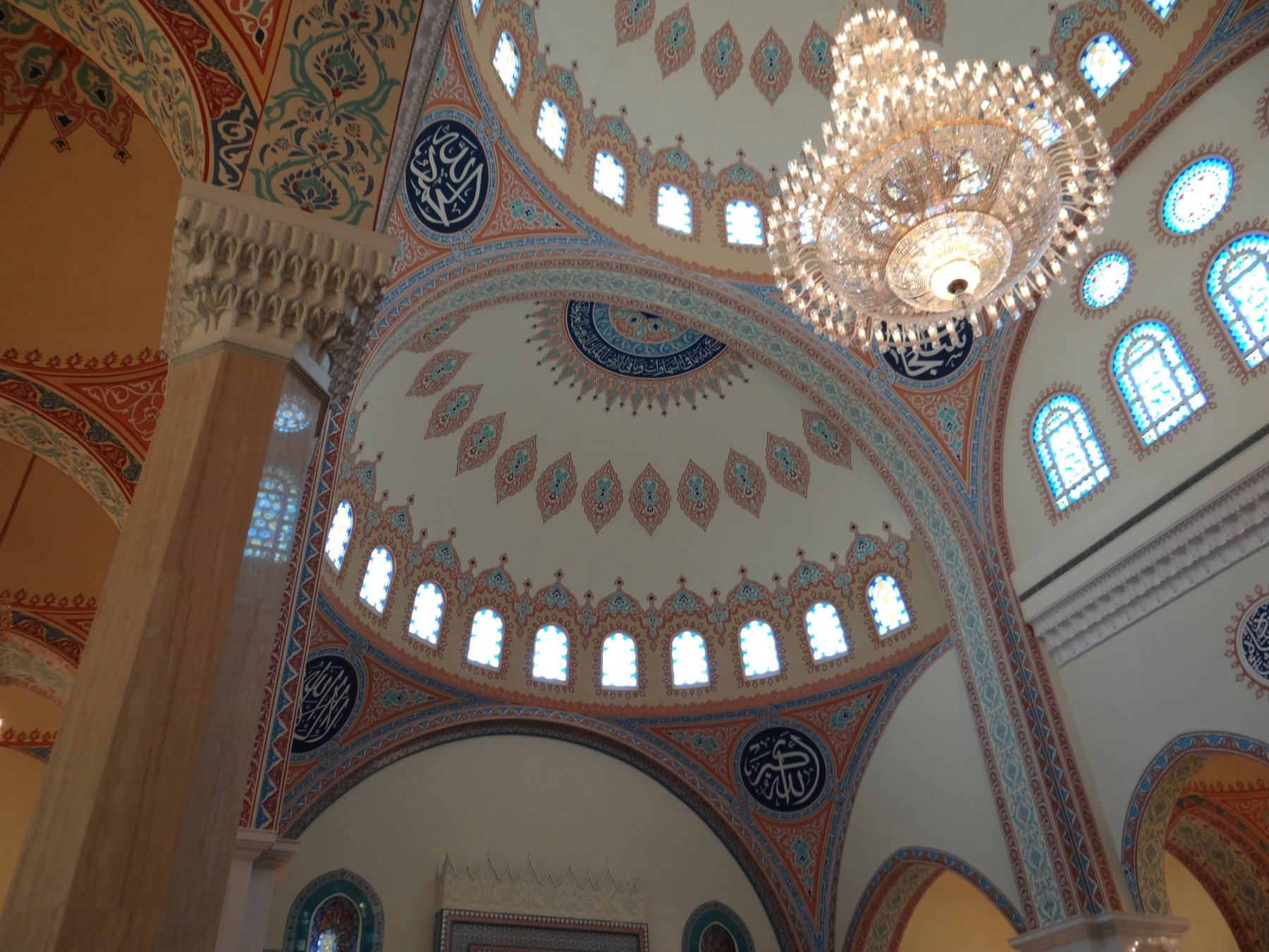 Decorative mosque dome with chandelier and painted geometric detailing