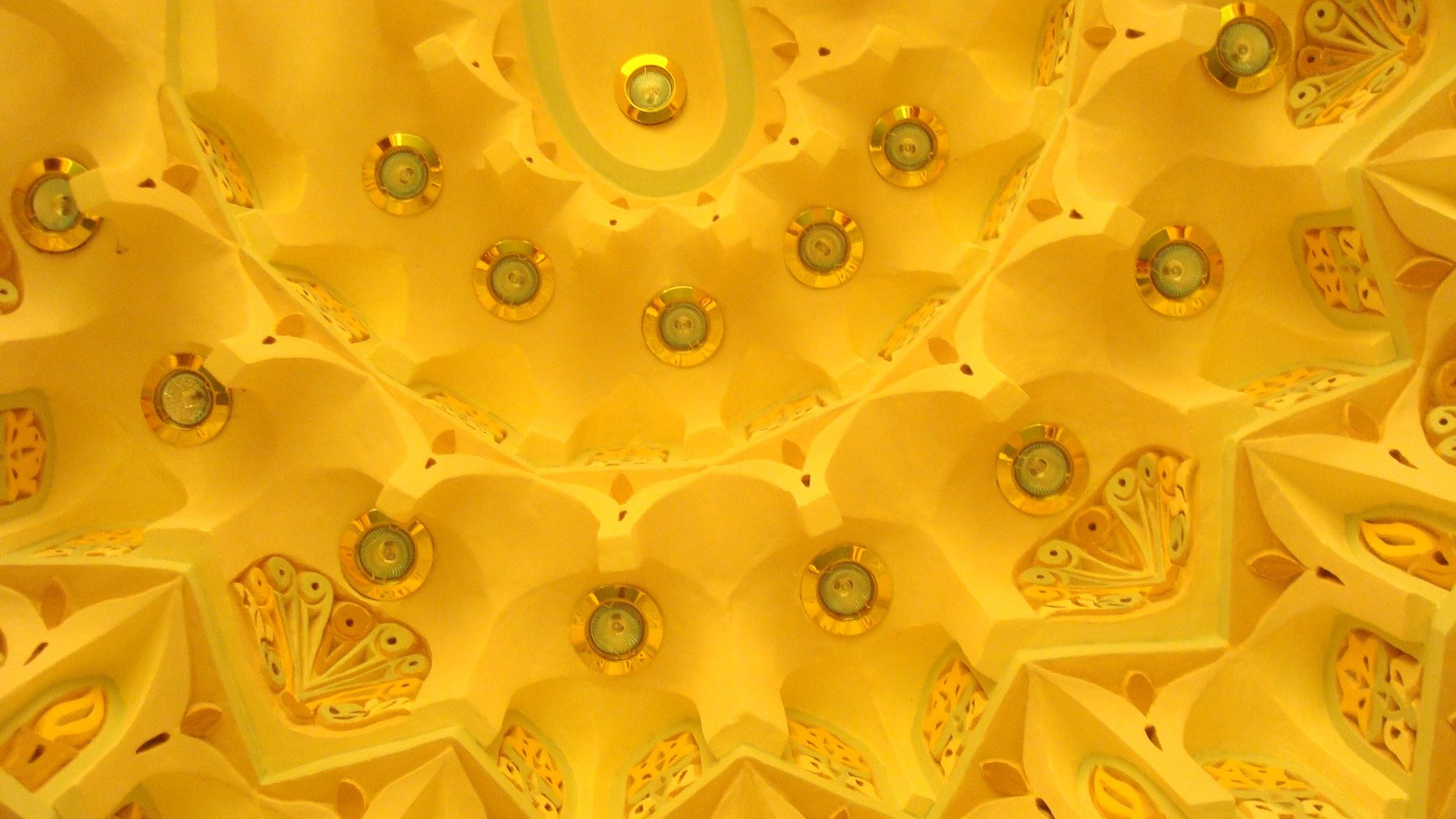 Decorative muqarnas ceiling detail with integrated recessed lighting