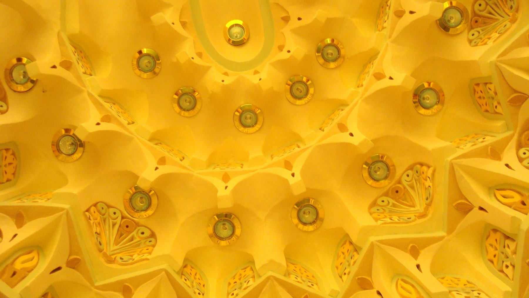 Decorative muqarnas ceiling detail with integrated recessed lighting