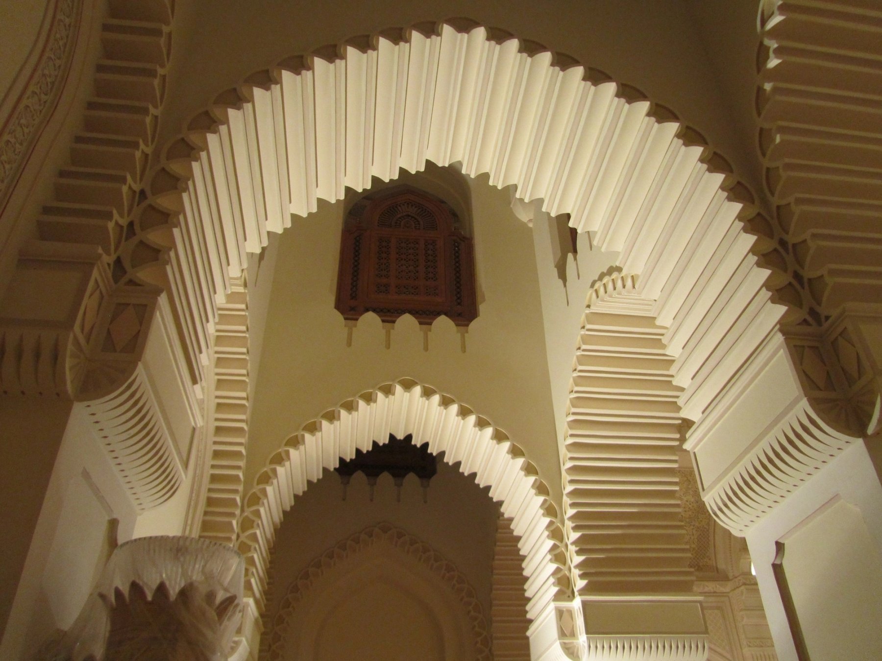 Layered pointed arches with sculpted plaster detailing and deep architectural reveals