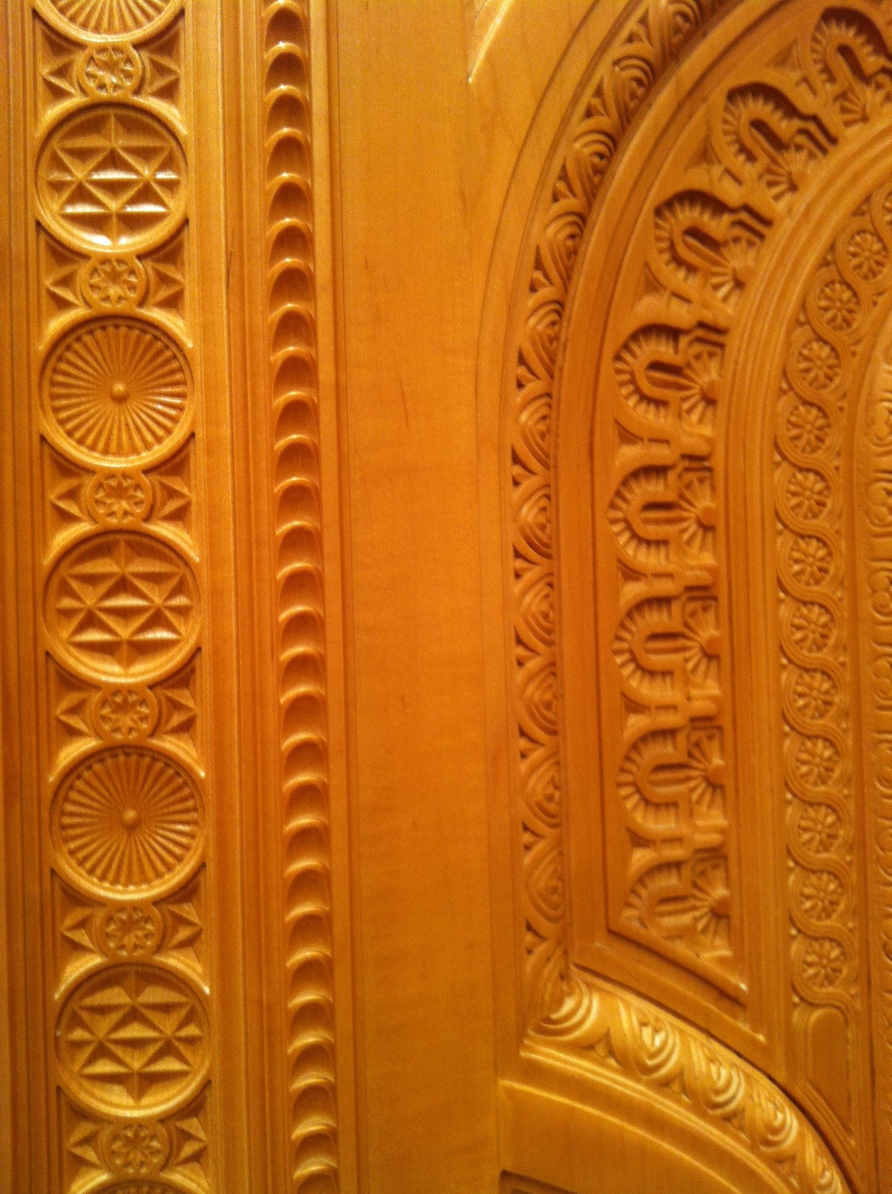 Close-up of hand-carved timber patterns and ornamental door detailing