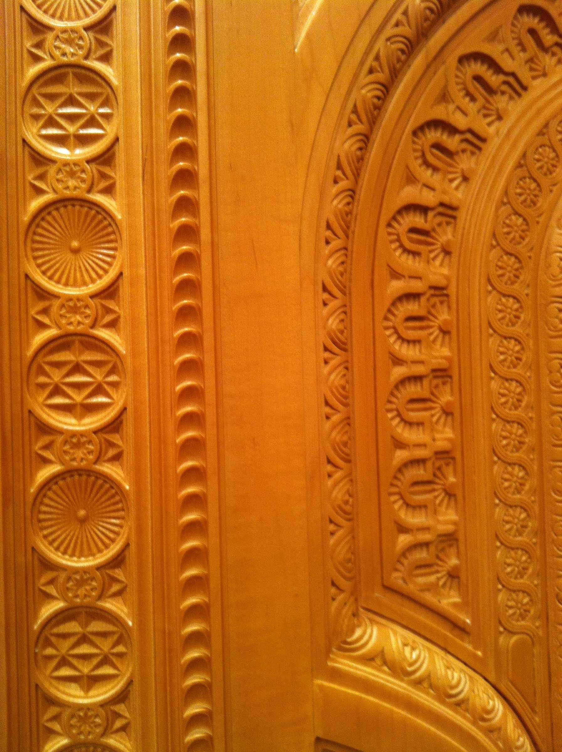 Close-up of hand-carved timber patterns and ornamental door detailing