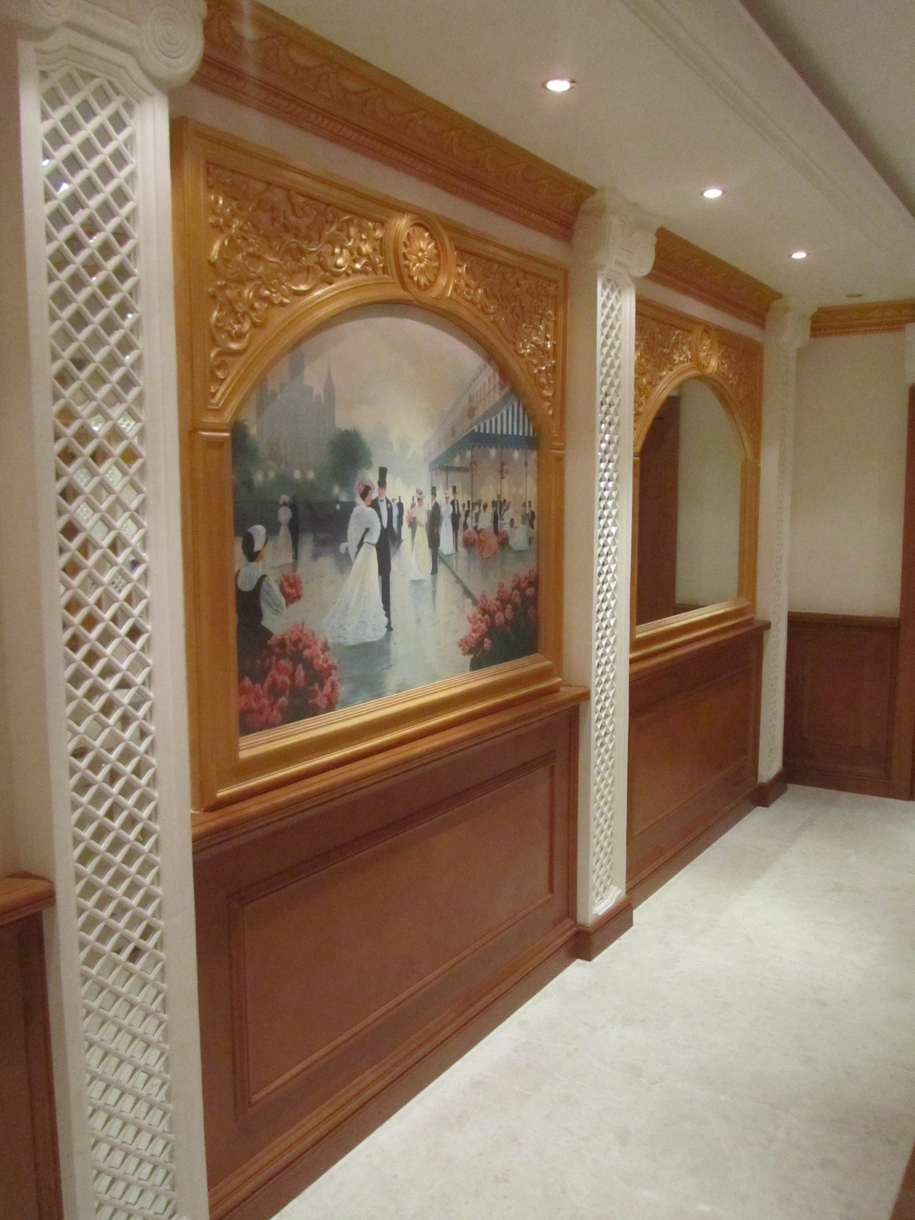 Decorative timber wall panelling with framed artwork and lattice column details