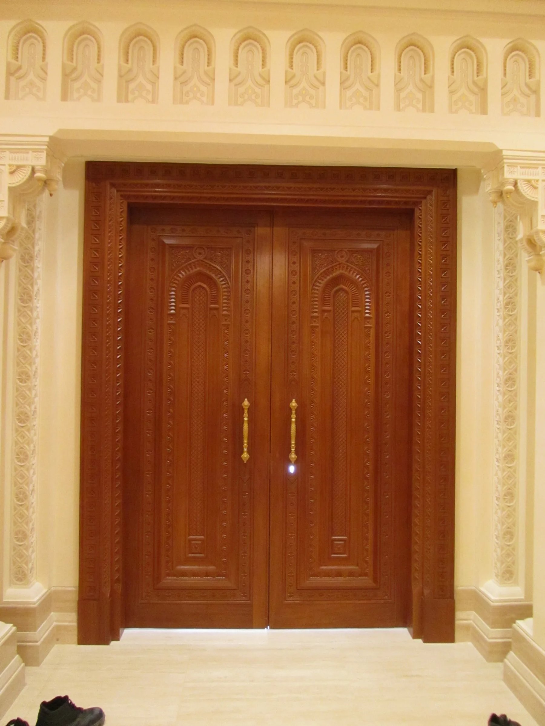 Ornate carved wooden double door showing bespoke joinery craftsmanship