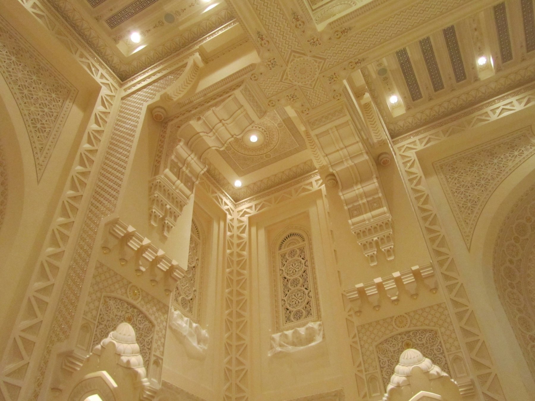Carved plaster columns and ceiling details with integrated architectural lighting