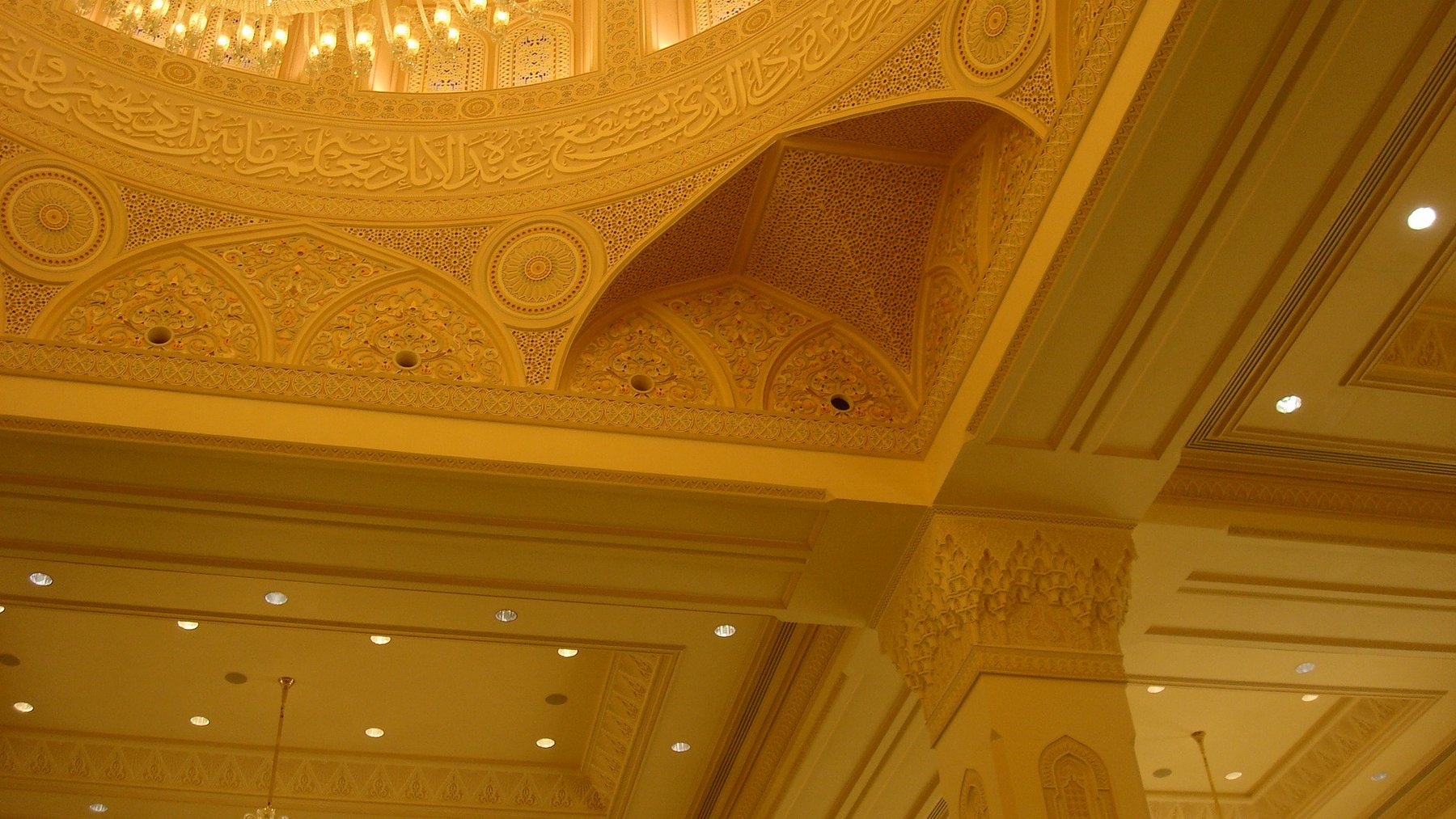 Close view of ornamental ceiling bands, carved details and architectural calligraphy