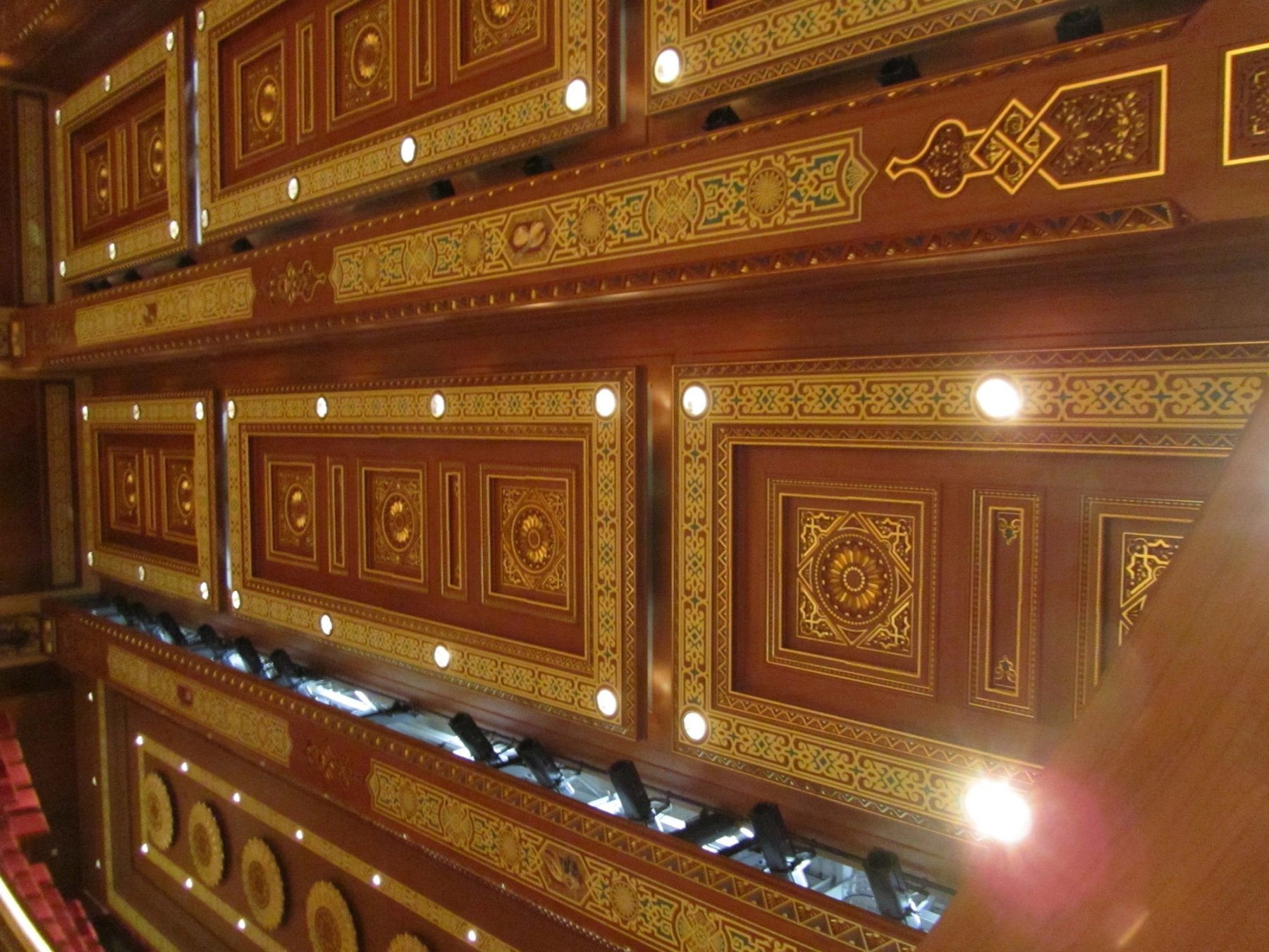 Decorative timber wall paneling with geometric and painted ornamental detailing