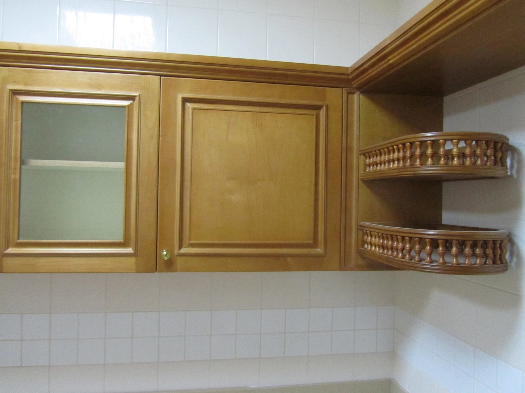 Custom timber kitchen cabinetry with open corner shelving