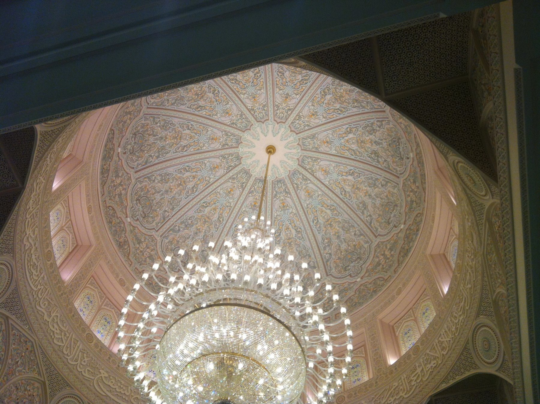 Domed ceiling with chandelier, carved borders and detailed interior ornamentation