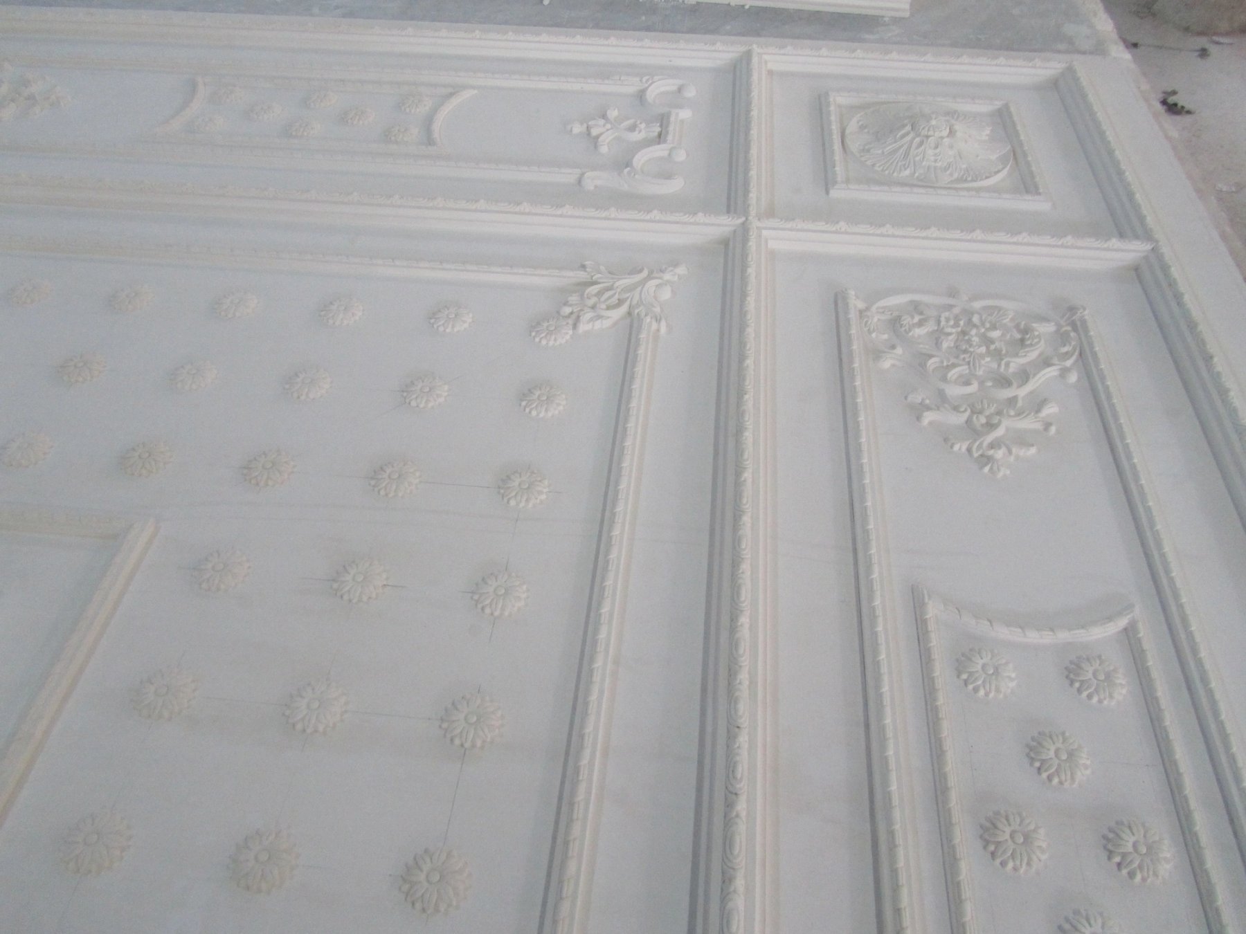 Ornamental plaster ceiling panel with floral mouldings and classical decorative relief
