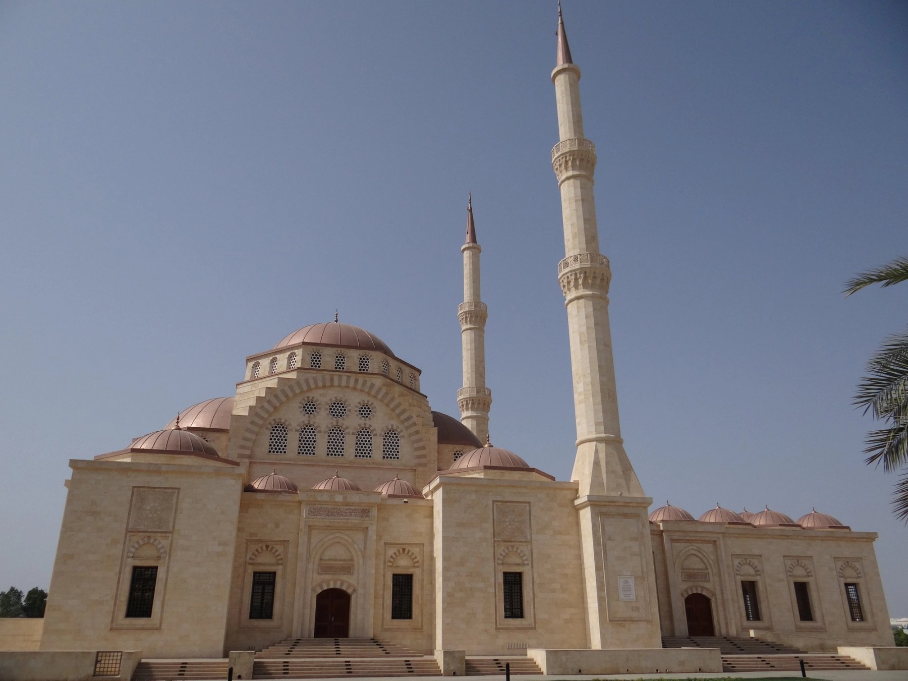 Exterior view of a mosque with domes and twin minarets