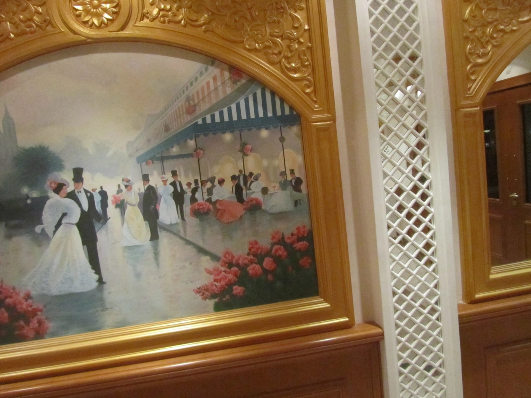 Framed decorative artwork set within carved timber and lattice architectural detailing