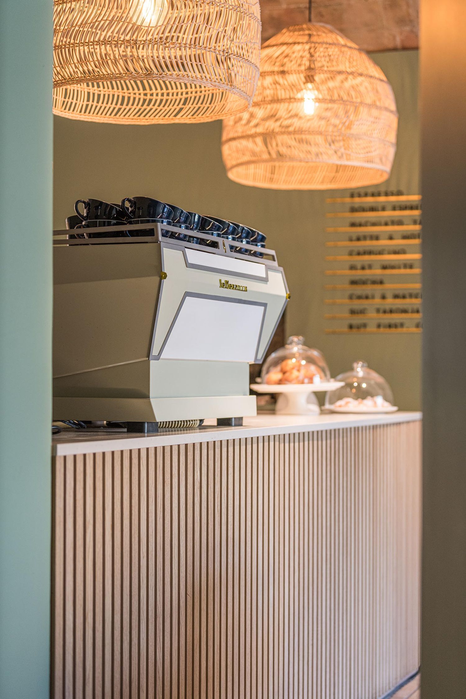 a coffee machine sits on a table at la comuna cafe