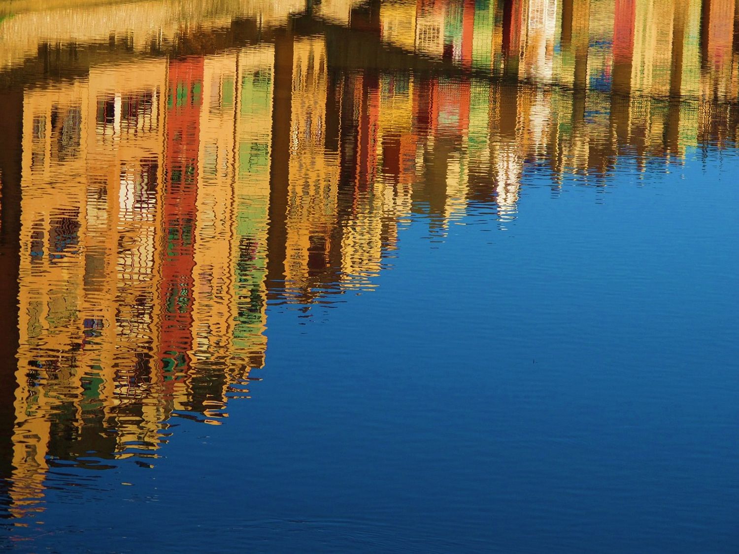 houses on the river onyar reflecting in the river