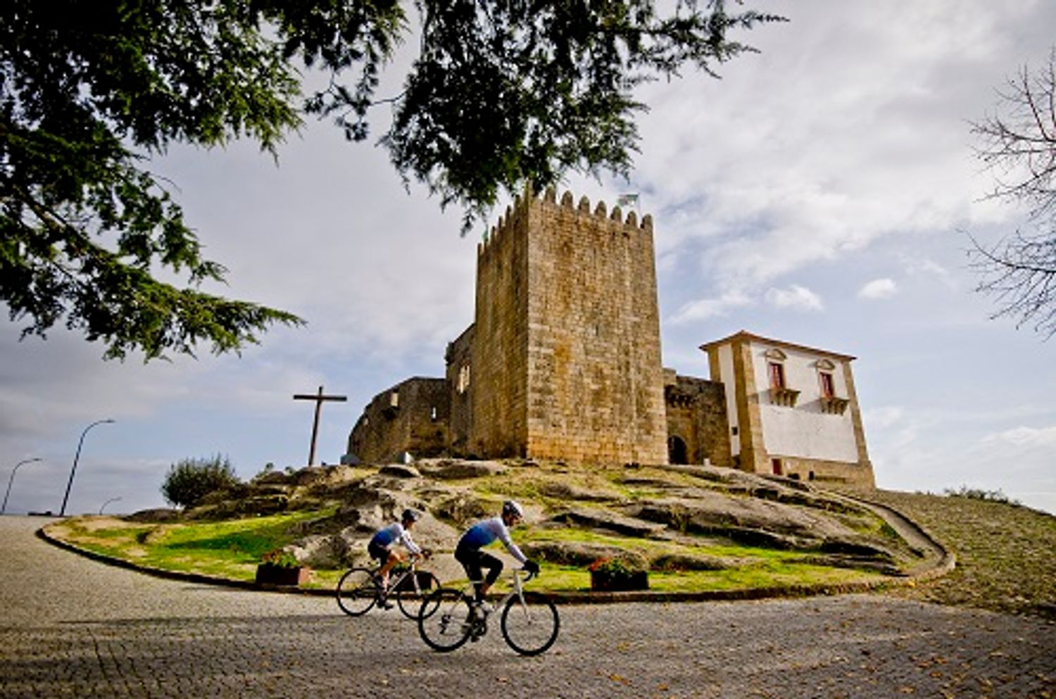 cyclists riding near a castle in portugal