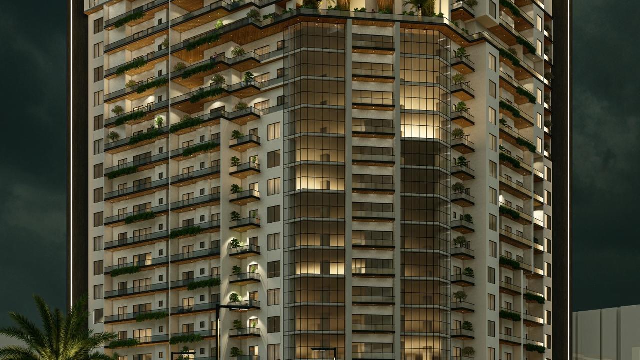 Night exterior render of Heaven 20 Heights high-rise apartment tower in Askari 11, Lahore, fully lit with landscaped drop-off and palm trees