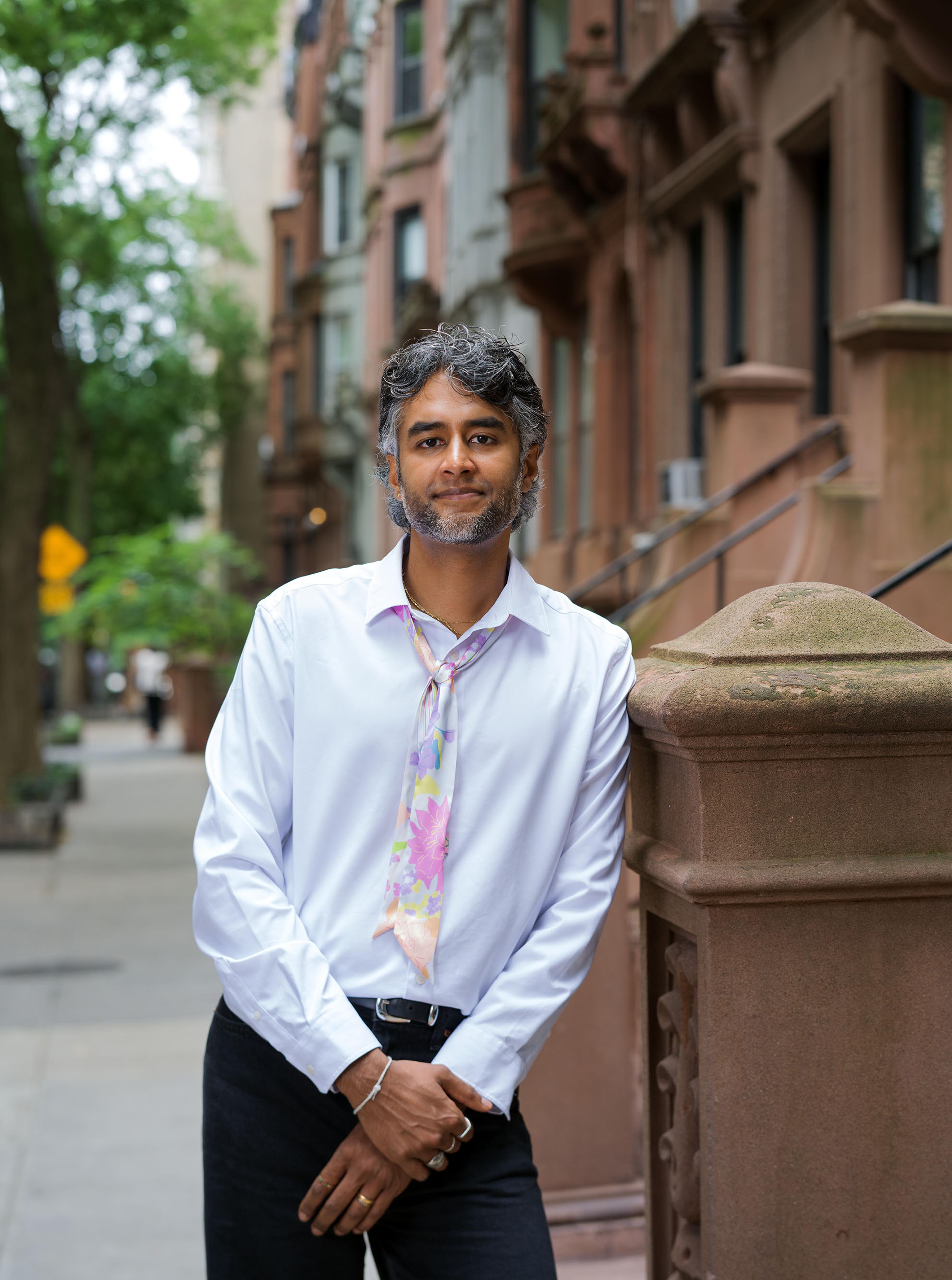 Dr. Kavin Fatehchand, MD-PhD, on a New York brownstone stoop.