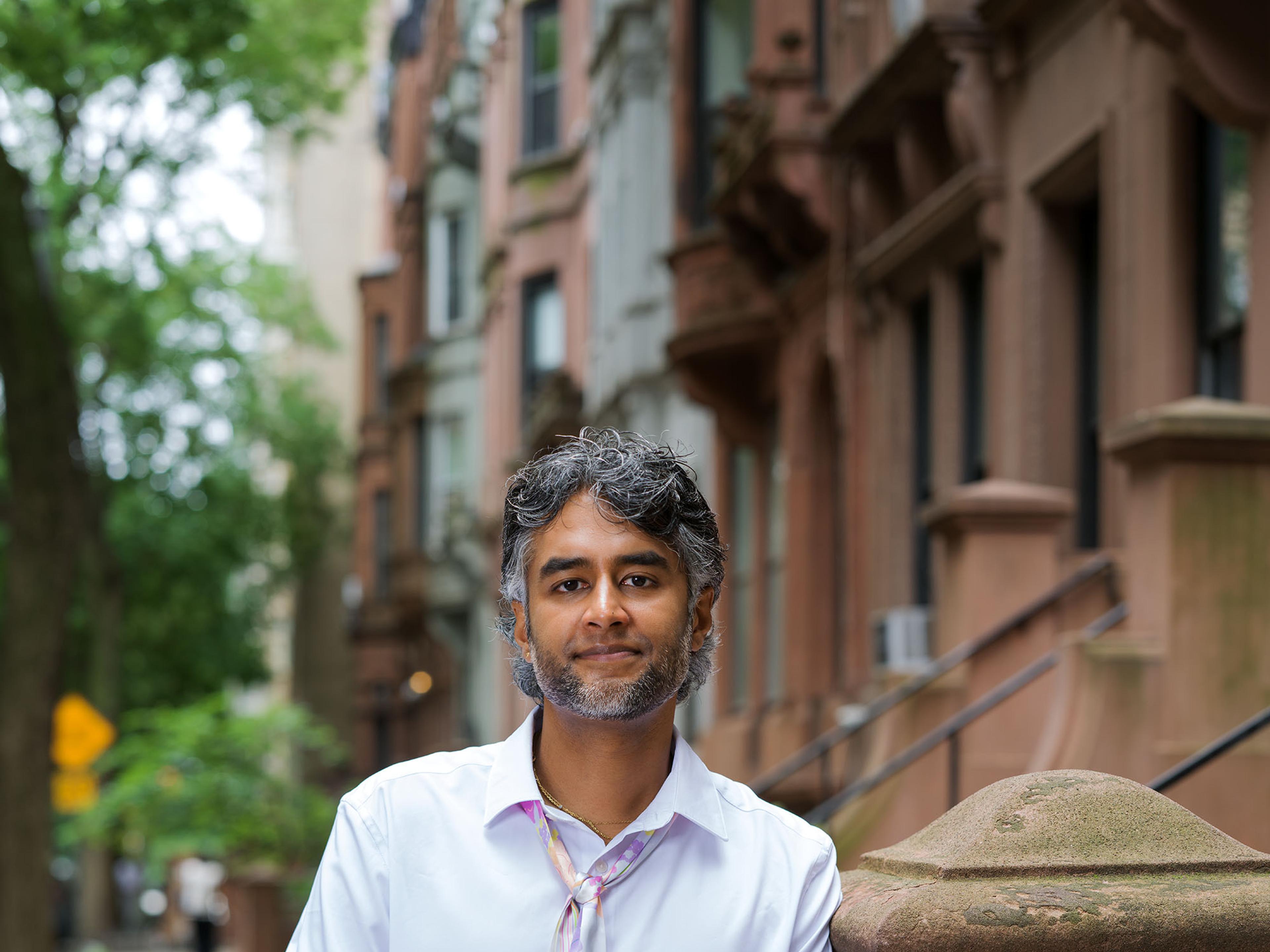 Dr. Kavin Fatehchand, MD-PhD, on a New York brownstone stoop.