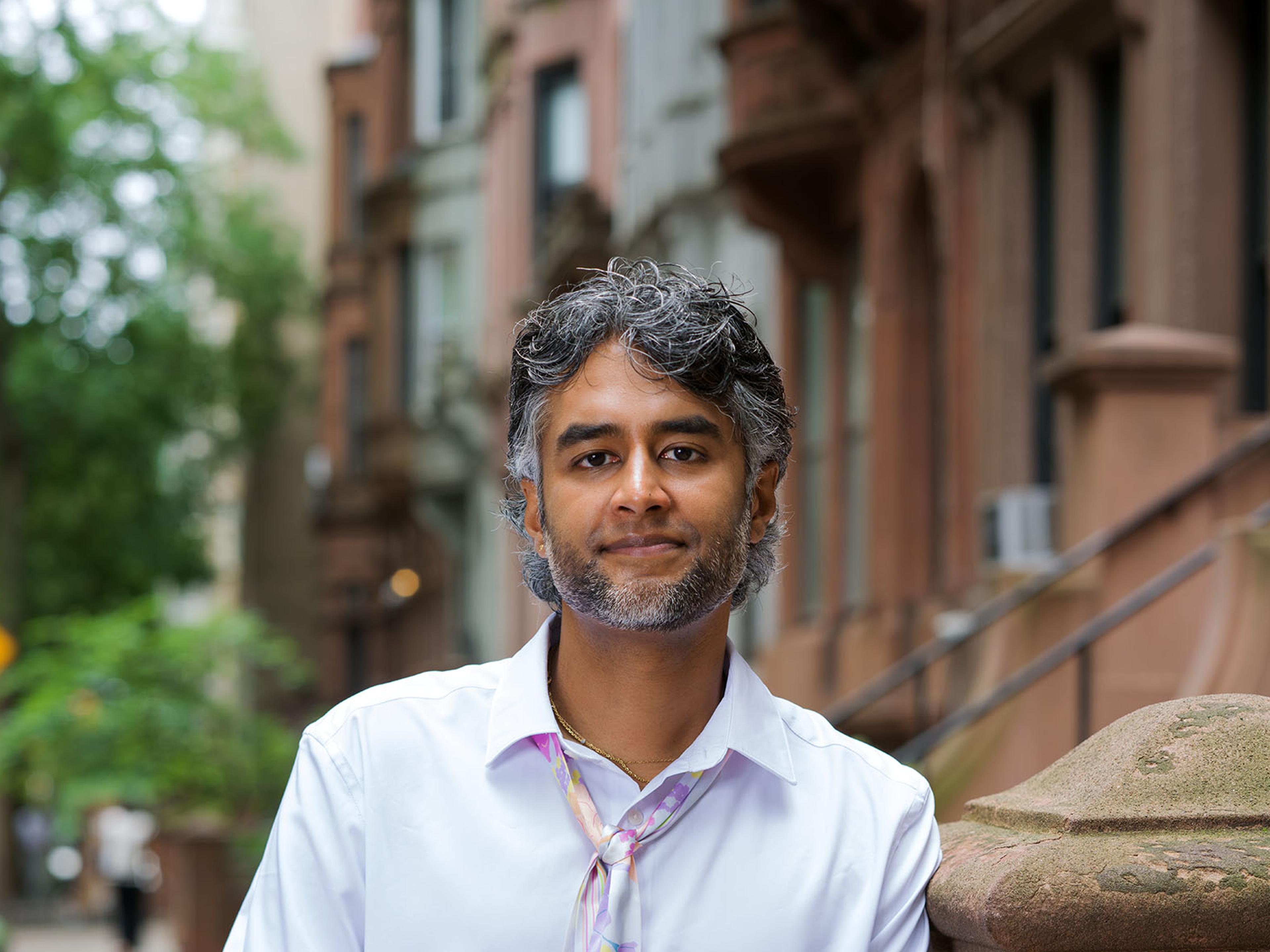 Dr. Kavin Fatehchand, MD-PhD, on a New York brownstone stoop.