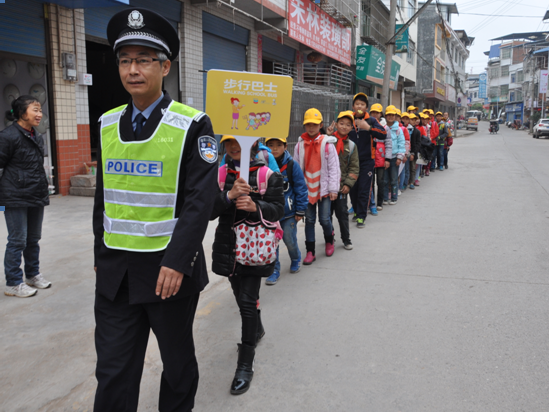 Traffic police guard children as they walk and spread awareness about pedestrian safety