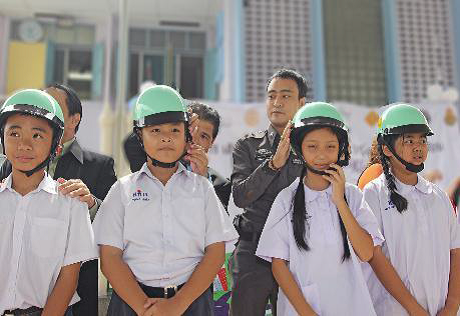 Students are fitted with quality helmets donated by ARRB during the project’s launch