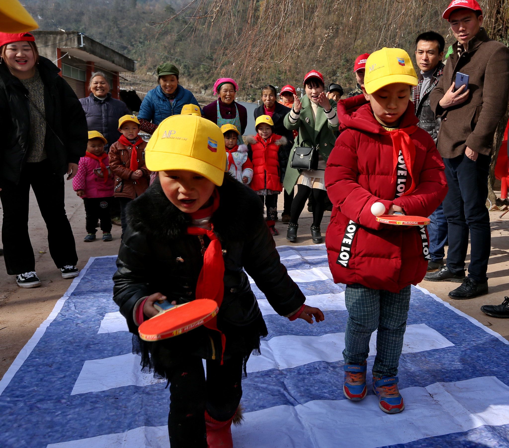 Students at Huazhu Primary School participate in interactive games to practice road safety skills.