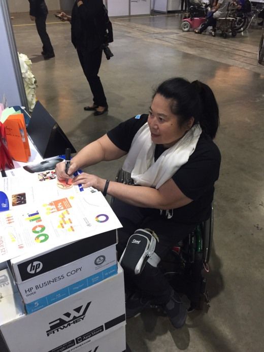 A conference attendee learns about AIP Foundation’s Street Wise program, supported by Chevron.