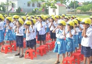 Students at No. 1 Hong Thuy primary school put on their new donated helmets