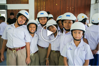 Students pose with their new helmets at the kick-off ceremony for Phase II of the Street Wise program in Songkhla Province, Thailand.