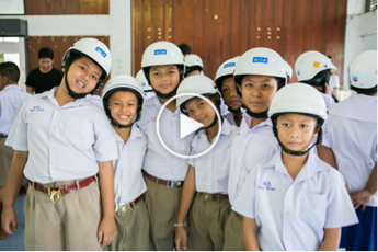 Students pose with their new helmets at the kick-off ceremony for Phase II of the Street Wise program in Songkhla Province, Thailand.