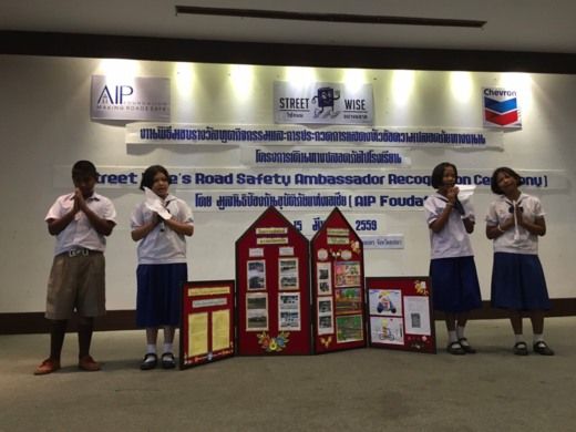 Student ambassadors perform on stage for a road-safety-themed competition during the ceremony.