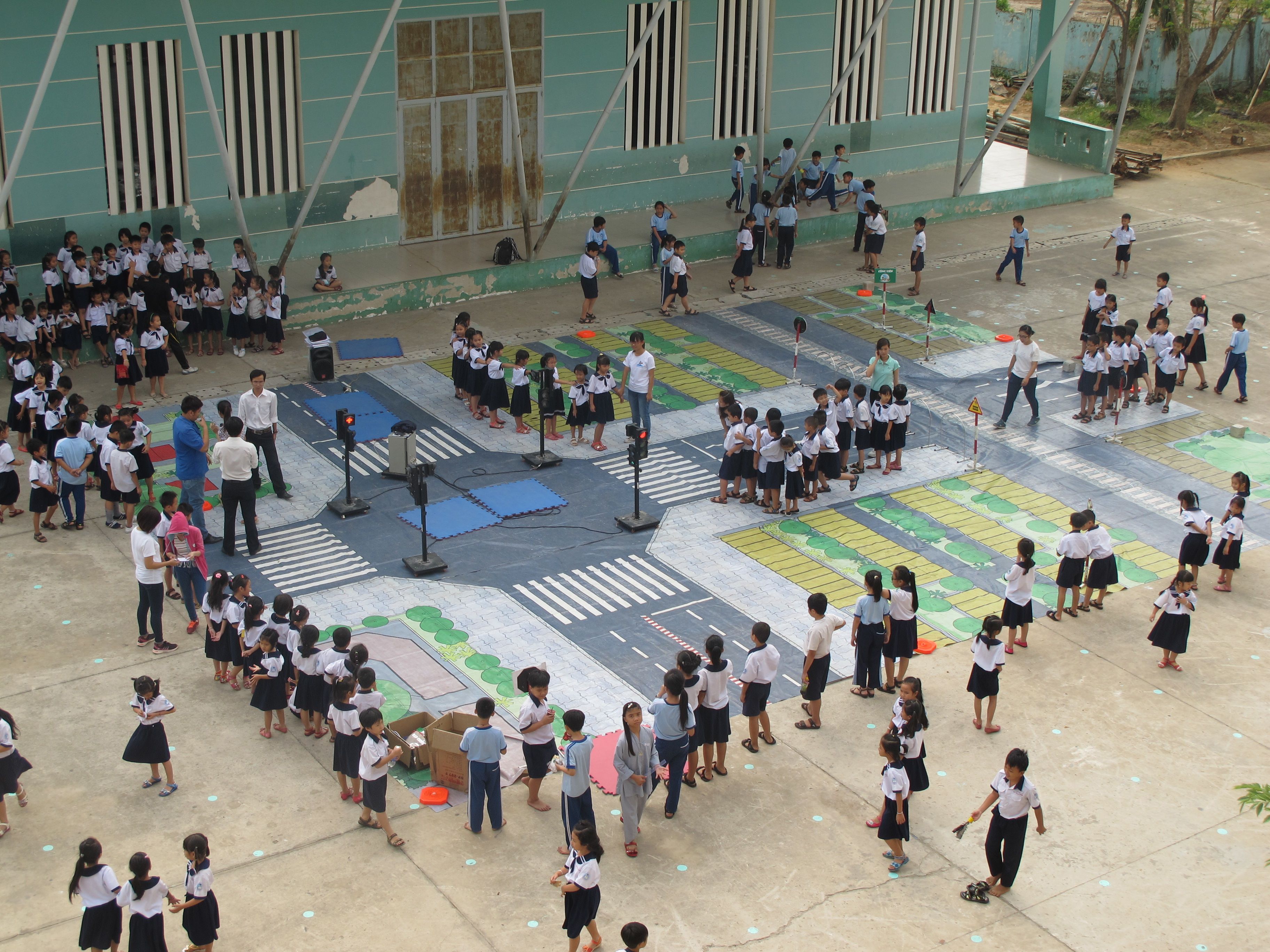 In AIP Foundation’s award-winning photo, students participate in a pedestrian safety simulation as part of the Walk This Way program in Vietnam, supported by FedEx Express and Safe Kids Worldwide.