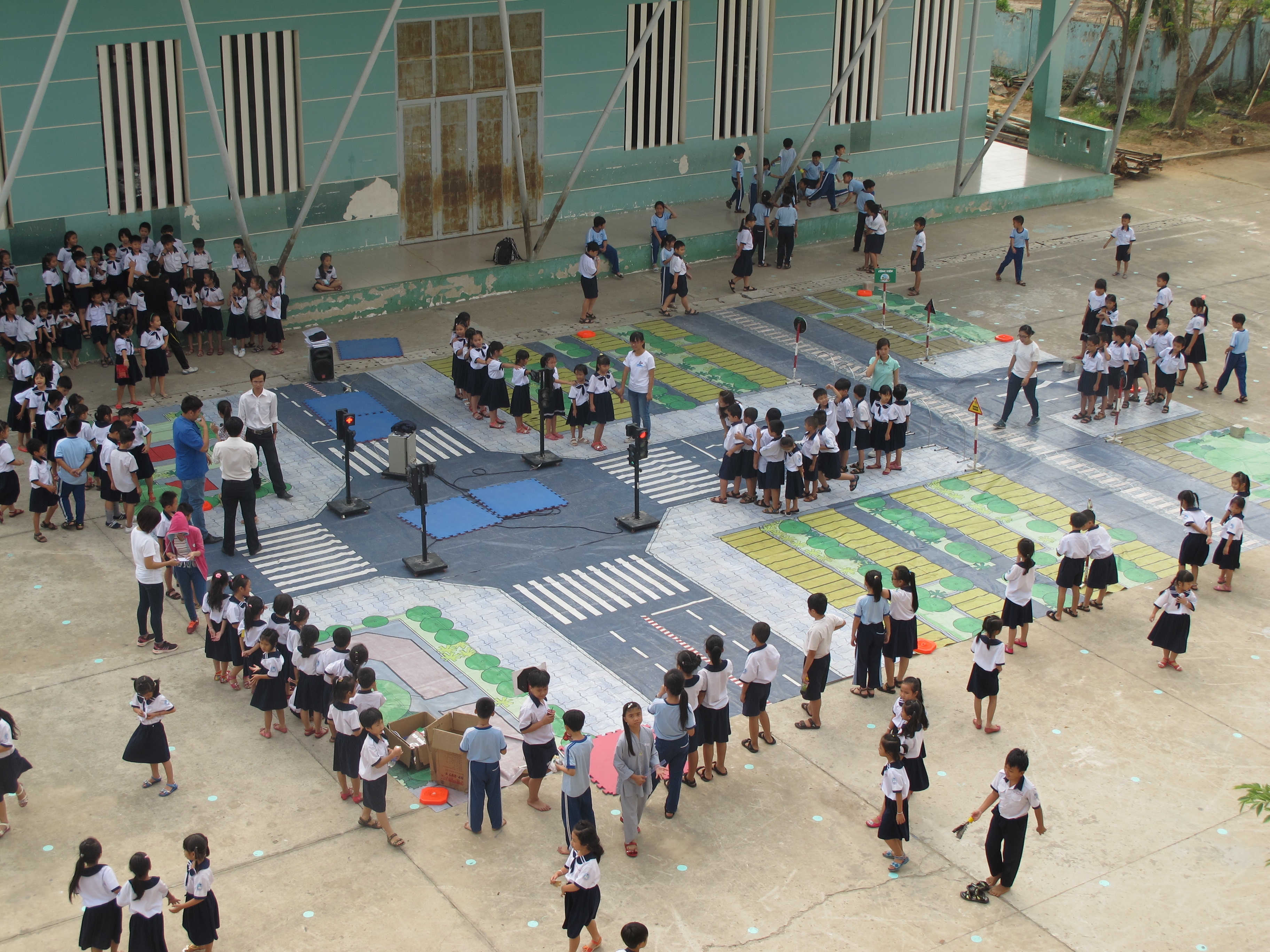 In AIP Foundation’s award-winning photo, students participate in a pedestrian safety simulation as part of the Walk This Way program in Vietnam, supported by FedEx Express and Safe Kids Worldwide.