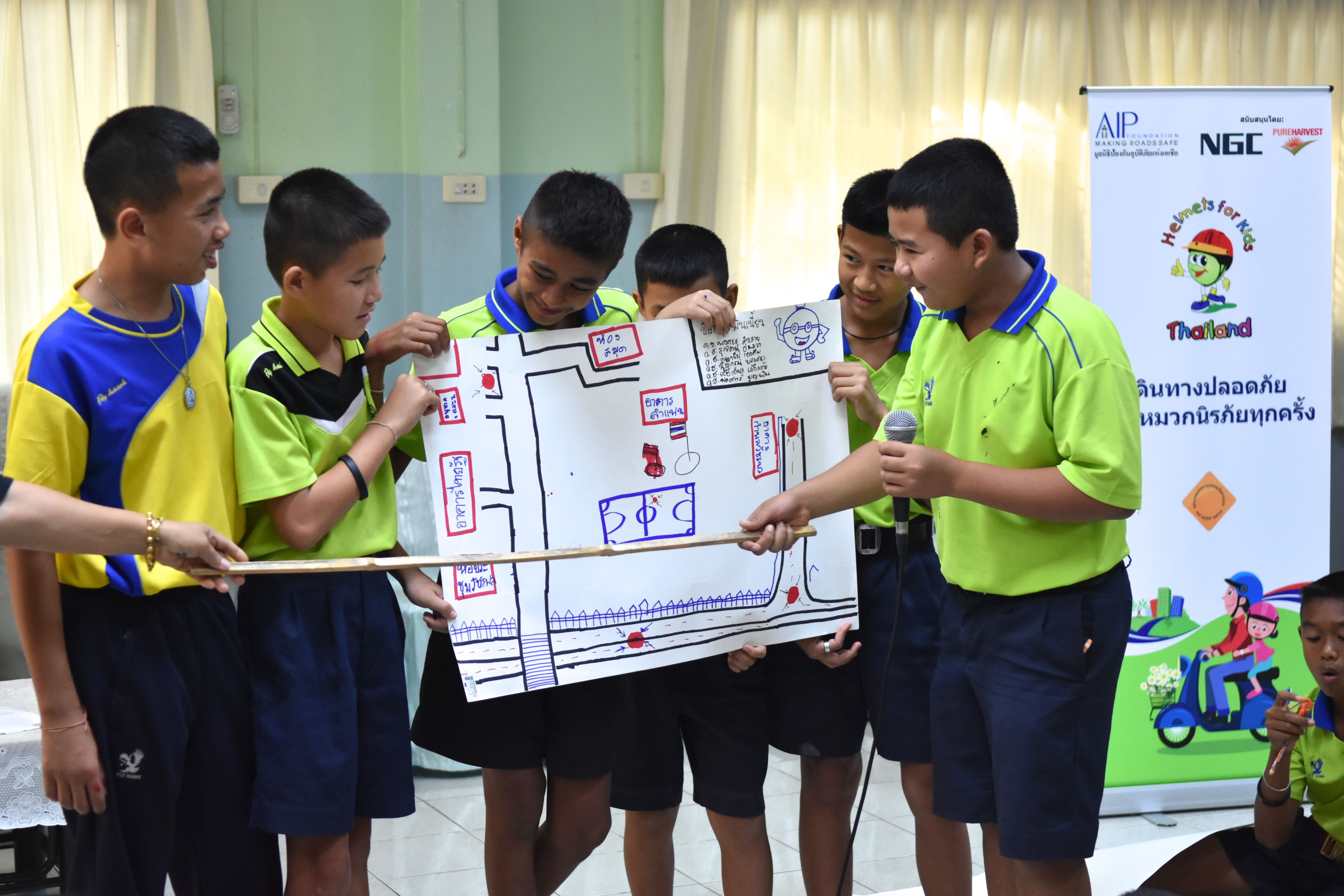 Students in Uttaradit Province participate in interactive extracurricular activities focused on raising awareness about the importance of wearing a motorcycle helmet.