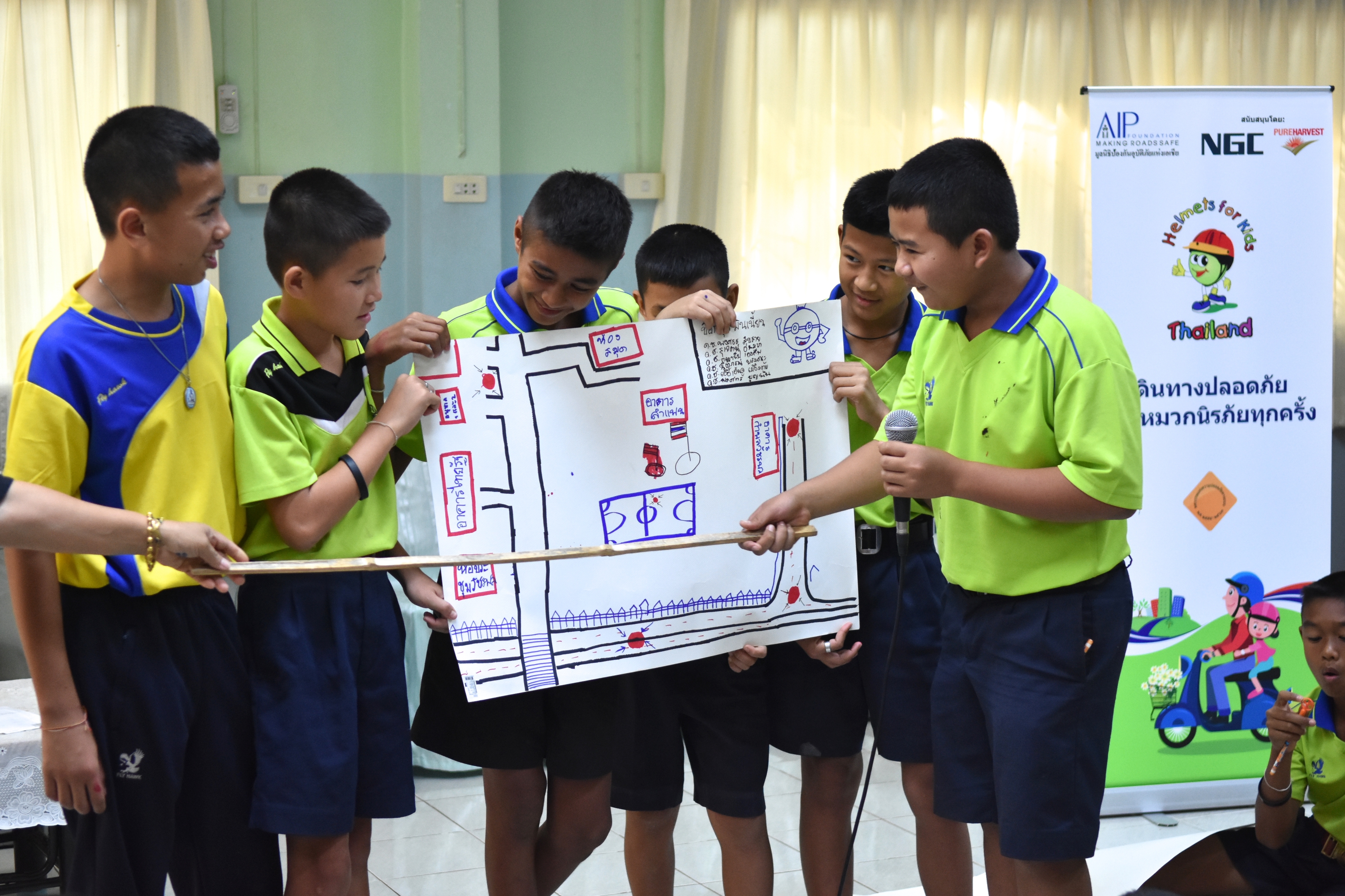 Students in Uttaradit Province participate in interactive extracurricular activities focused on raising awareness about the importance of wearing a motorcycle helmet.
