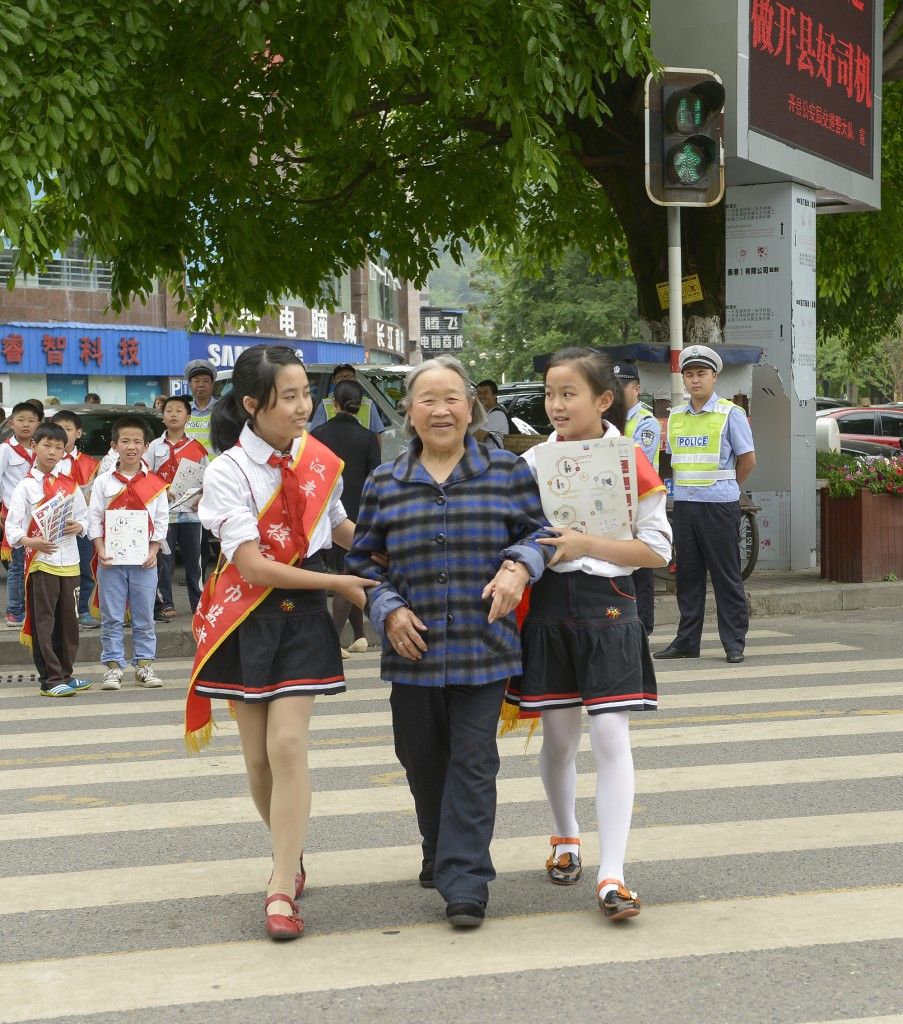 Students help their community cross the street safely