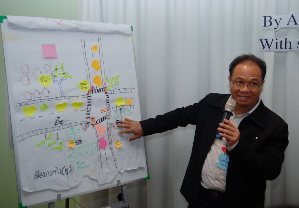 A workshop participant presents to the group of gathered stakeholders on how media can more effectively be utilized to effect change.