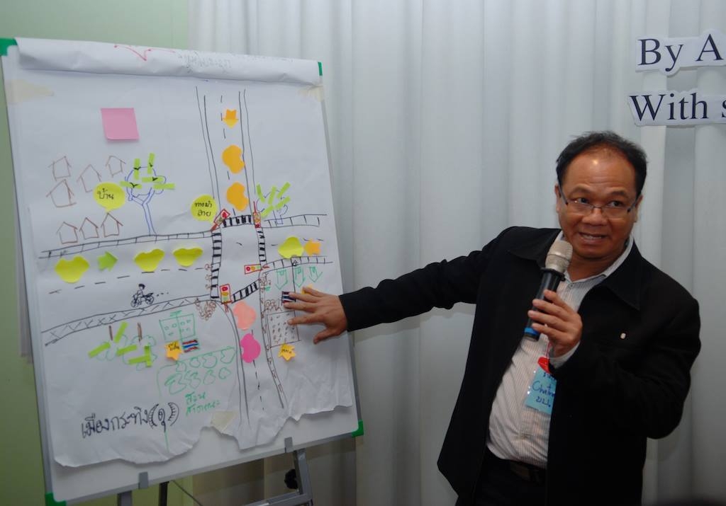 A workshop participant presents to the group of gathered stakeholders on how media can more effectively be utilized to effect change.