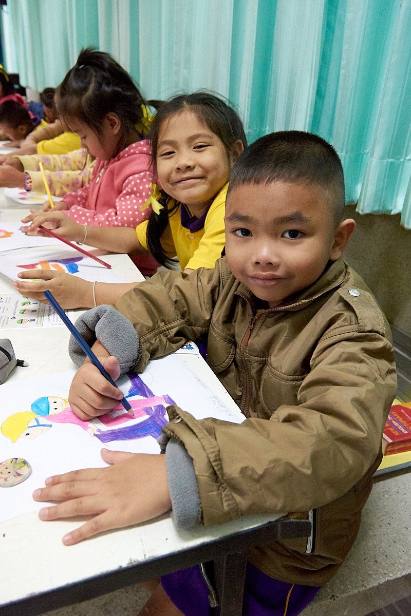 Students learn about road safety concepts through fun coloring activities organized by their teachers.
