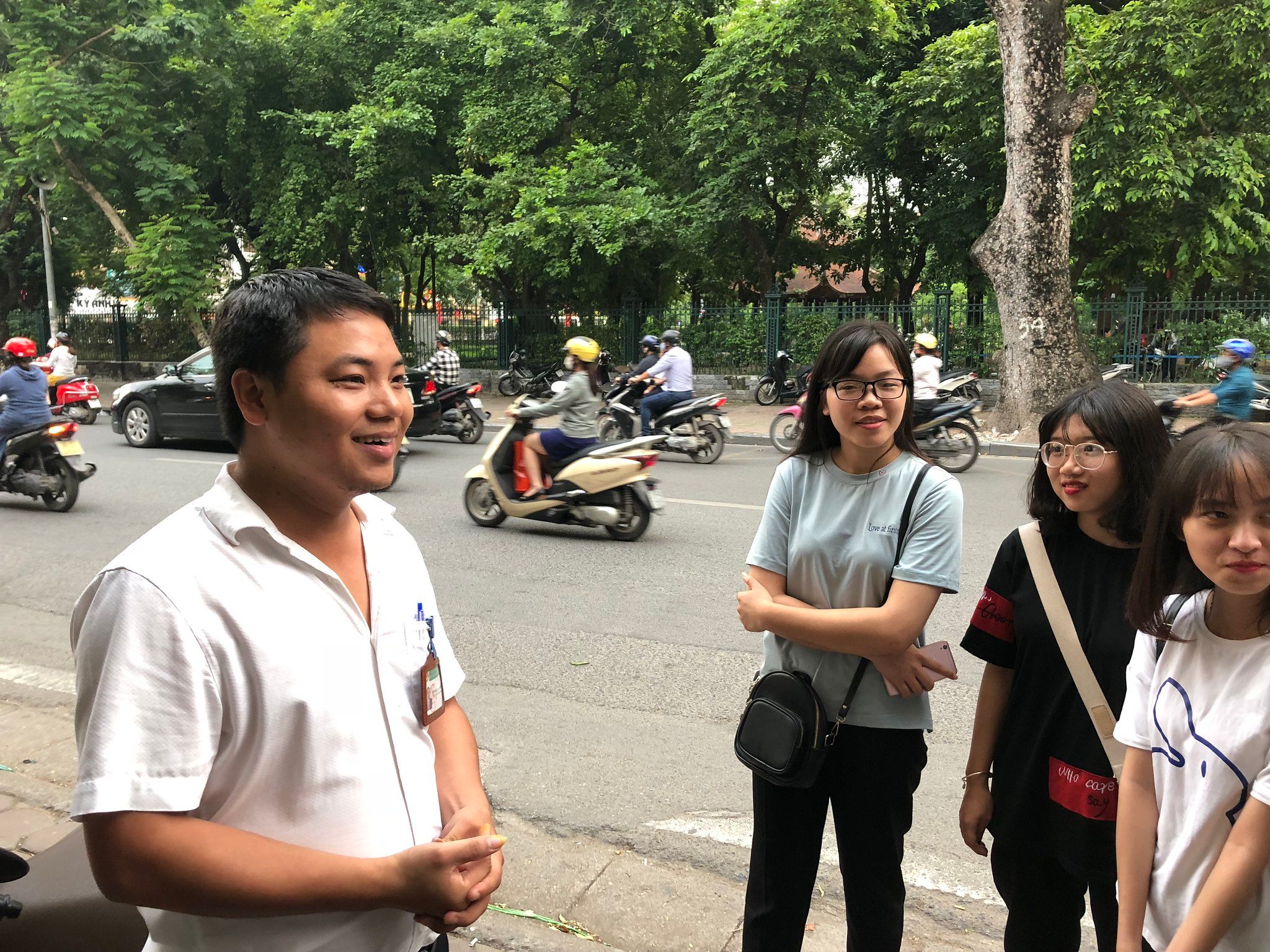 Youth road safety ambassadors and a representative from the government discussing prior to a manual data collection.