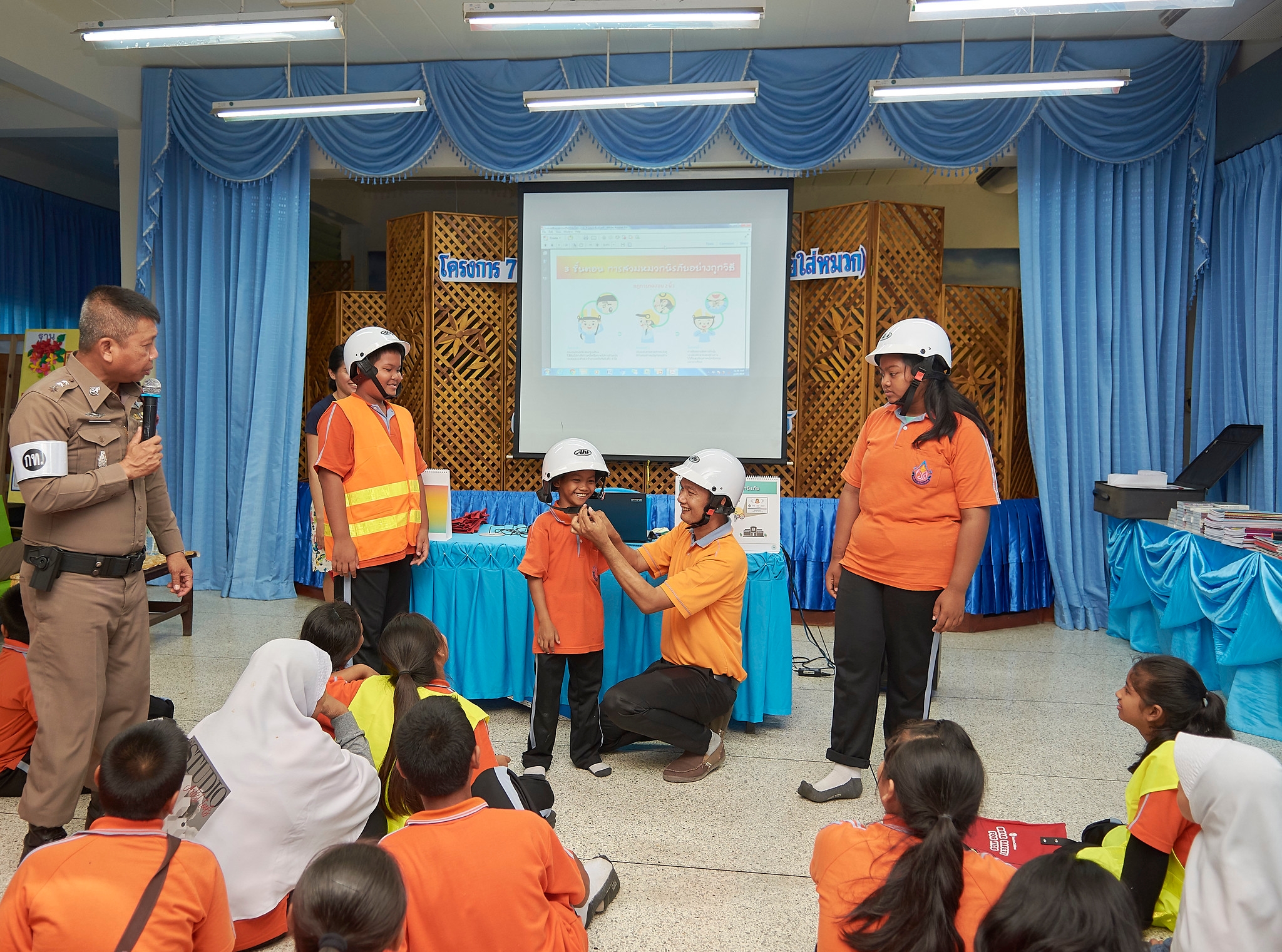 Students learning the correct way to wear a helmet.