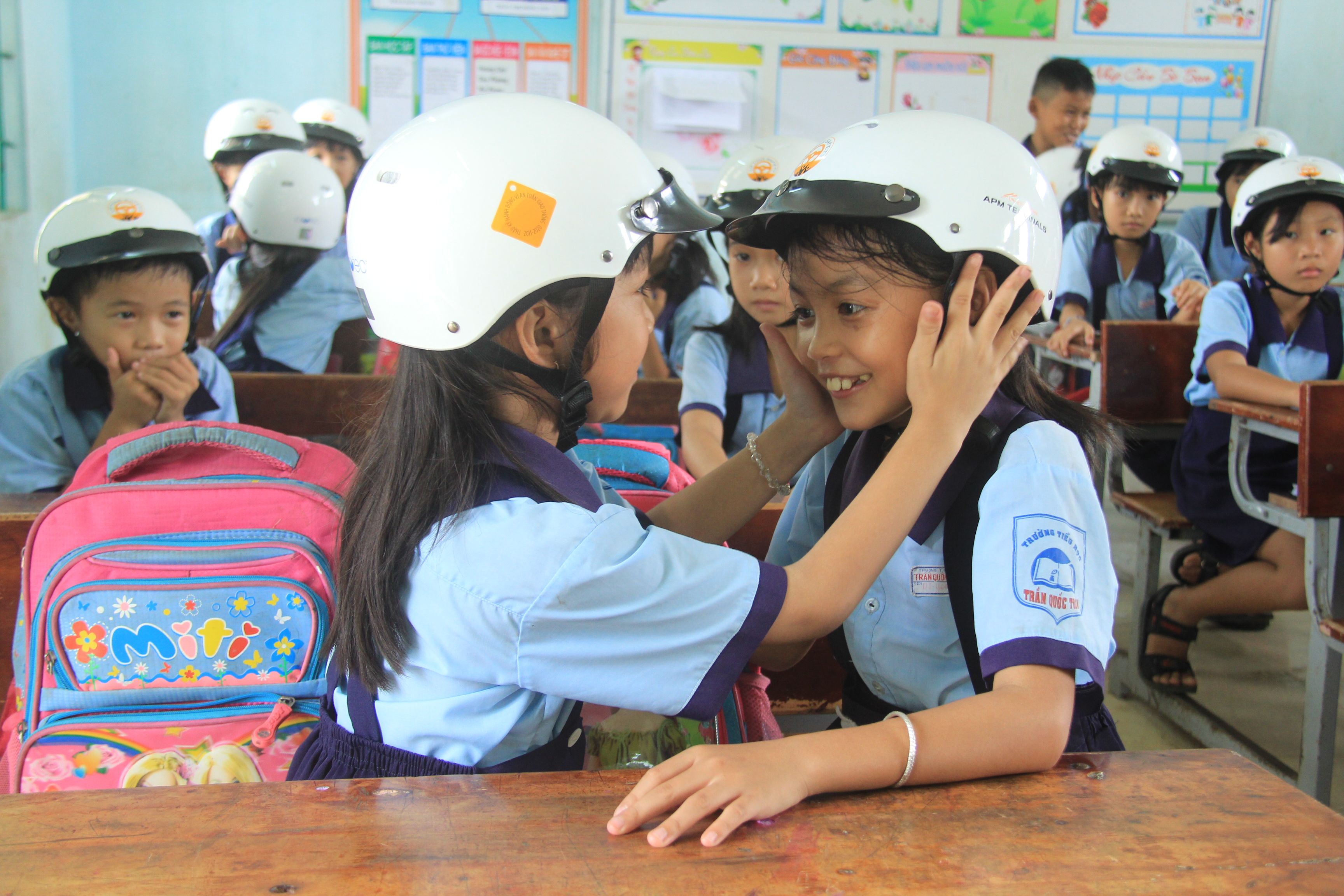 AIP Foundation’s submission to the GlobalGiving photo contest features students in Vietnam helping each other wear their new helmets.