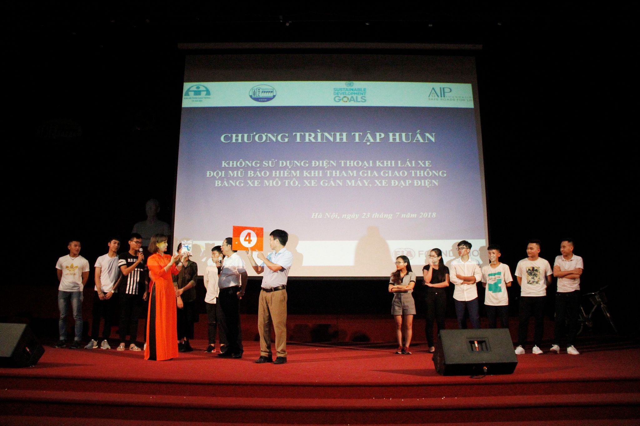 Students play a traffic safety game onstage with workshop facilitators