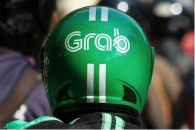 A Grab bike rider’s helmet in traffic.