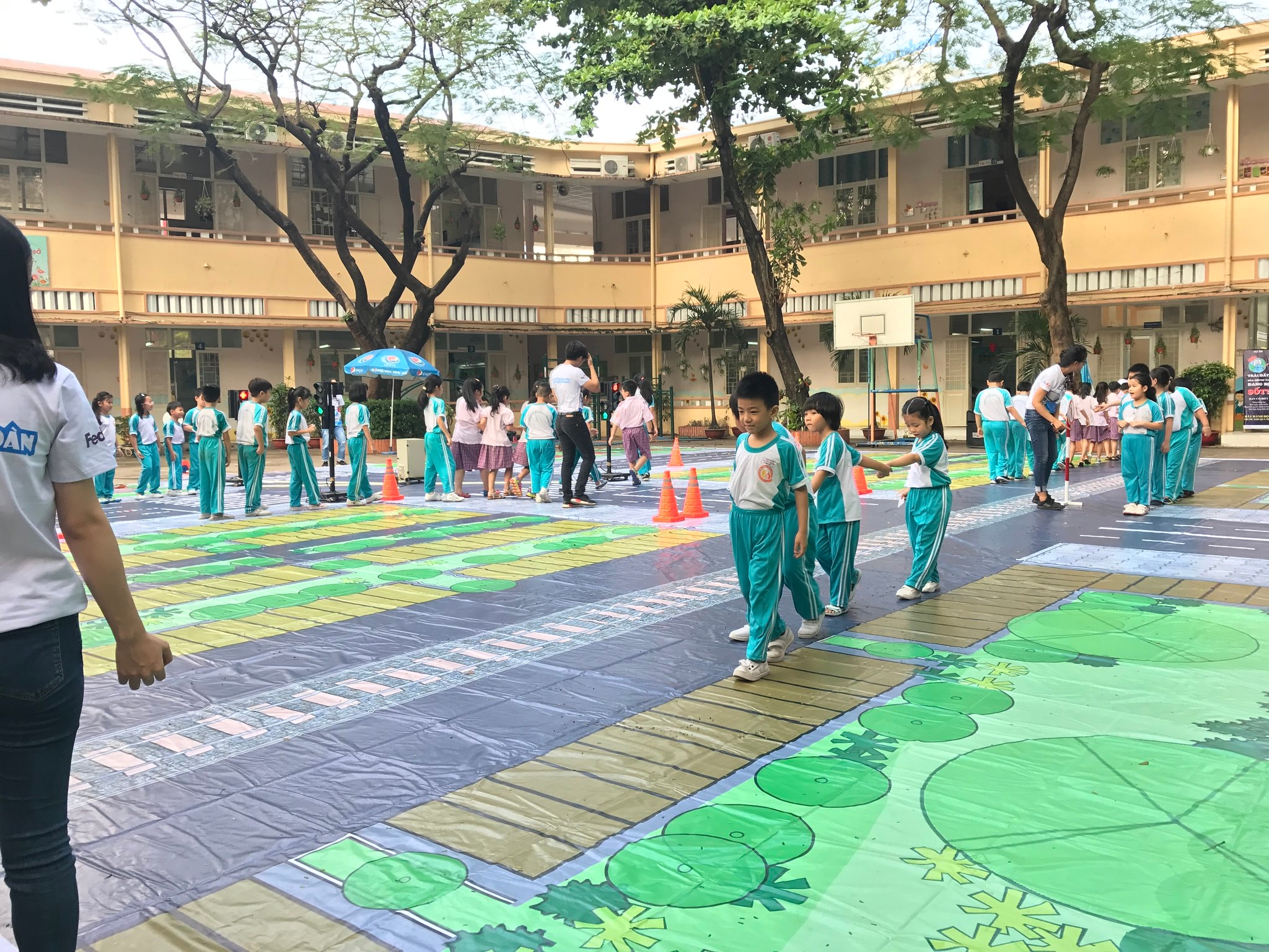Students simulate different pedestrian safety situations as part of a training organized by the Walk With FedEx Tour.